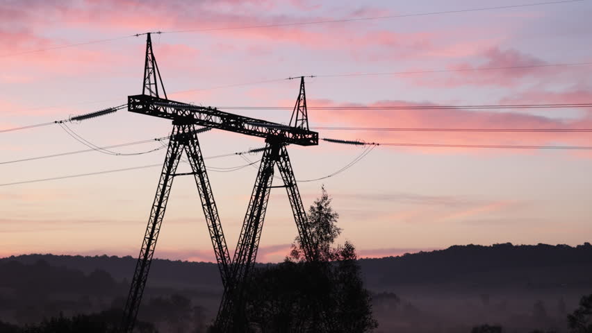 Transmission technology, Tower plains, Power sunrise. Steel transmission towers enabled power engineering across wide-open rural landscape and fields. Royalty-Free Stock Footage #3425396653
