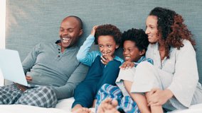 Black family, bed and laptop with movie, smile and streaming series in the morning. Laughing, computer and happy father with children and mother together with care, meme and web video at home online