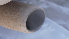 Video of the visible white smoke coming out from a car rusty exhaust muffler, highlighting environmental concerns, close-up shot.