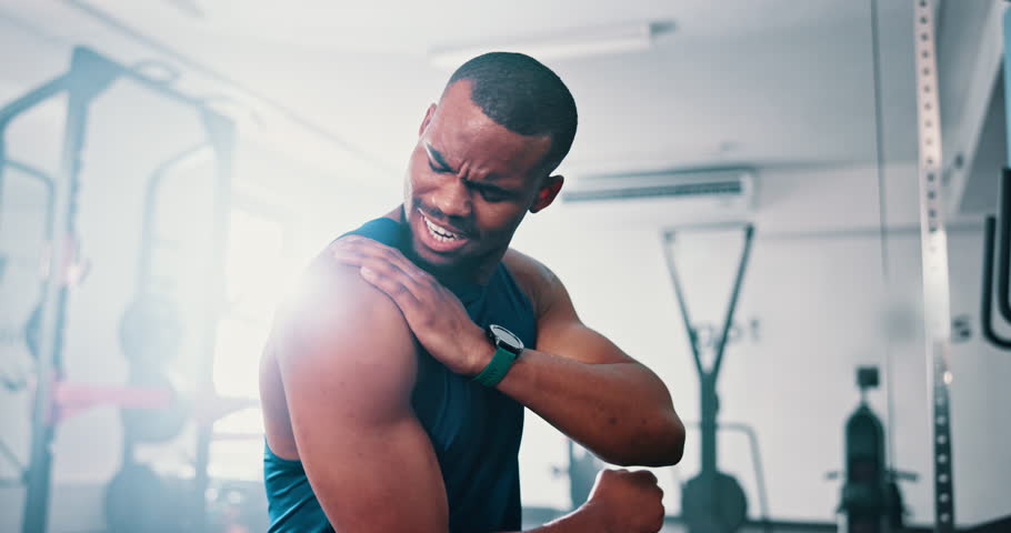 Gym, shoulder pain and black man with fitness, injury and inflammation with workout and burnout. Accident, African person and athlete with arthritis and muscle tension with exercise and fibromyalgia Royalty-Free Stock Footage #3425561683
