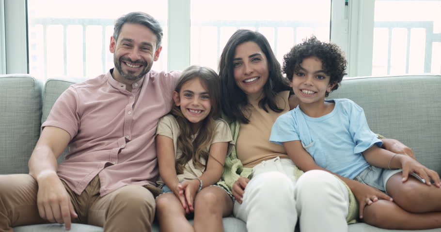 Happy middle aged Latin parents and two kids looking at camera with toothy smiles, starting tickling each other, screaming, laughing, enjoying family leisure, activity, entertainment, having fun Royalty-Free Stock Footage #3425641295