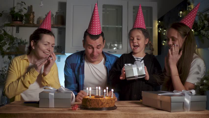 Happy family concept. birthday at home with family. cake with candles on table. family celebrates the holiday. blow out candles. happy birthday. candles on the cake. happy family celebrating birthday