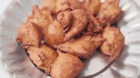 Fried pakoda or pakora with vegetable filling, popular Indian snacks. Rotating video