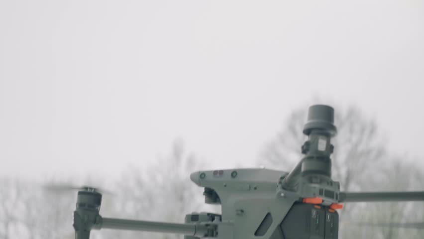 An operator lands a drone in the snow.