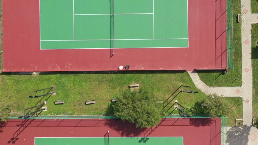 Top view of tennis court. Bird eye view of new empty tennis court in sunny day Royalty-Free Stock Footage #3425827707
