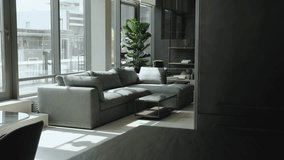 Gray color interior design with large gray sofa with many pillows and marble table in luxury apartment living room, slow motion shot. - Powered by Shutterstock - Get 15% off with code: PIKWIZARD15