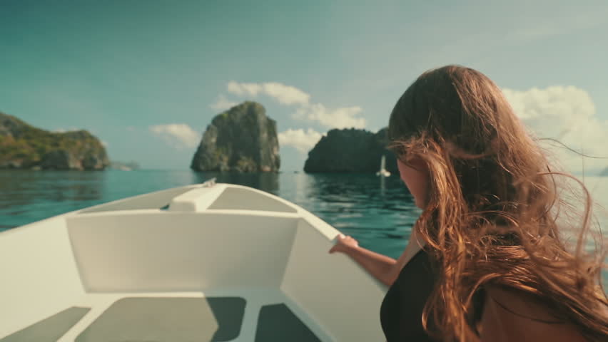 Girl sailing speed boat slow motion wind blow long hair. Young adult female enjoying fast ride on a motorboat. Feeling alive, and free concept. Travel holidays tour to Philippines, El Nido Islands. Royalty-Free Stock Footage #3425890153