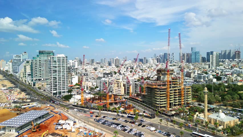 Tel Aviv-Yafo, Israel, October 10, 2023. The process of building a hotel complex on the Tel Aviv embankment. Against the backdrop of skyscrapers. 4K