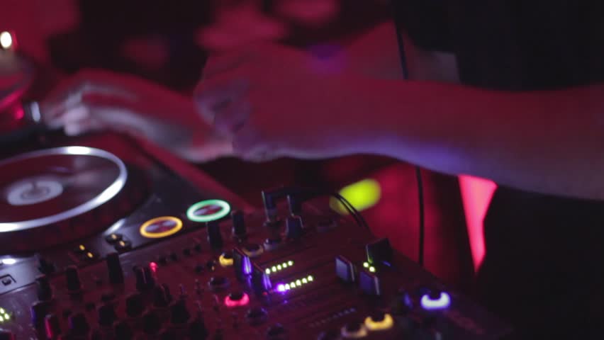 Dj's hands during the party in night club
