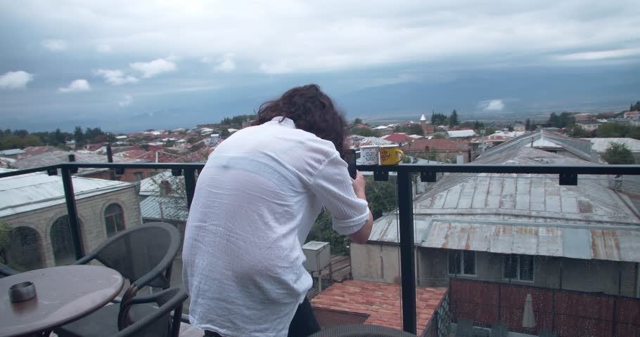 Girl taking pictures of a small town