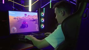 Gamer Enjoys Video Game Hobby By Playing Buggy Car Racing Simulator. Gaming Hobby. Gamer Gains Score Achieving Great Speed In Desert Race Simulator. Young Gamer. Drifting Simulator Hobby