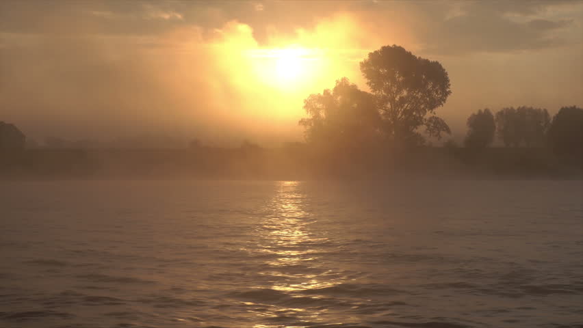 Sunrise over the Rhine River on misty morning, The Netherlands