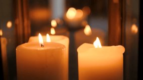 Two candles are burning near a mirror in a dark room. Close-up of candle flame in a romantic setting - Powered by Shutterstock - Get 15% off with code: PIKWIZARD15