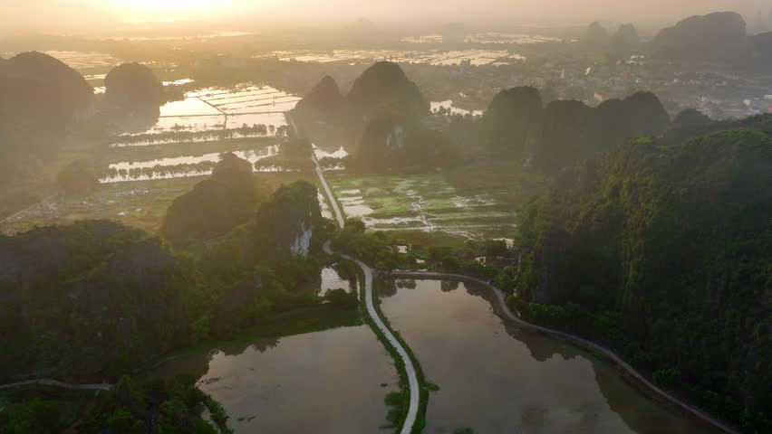 Vietnam nature, beautiful sunrise in Vietnamese mountains in Ninh Binh, aerial view of foggy dramatic sunrise in Vietnam . High quality 4k footage