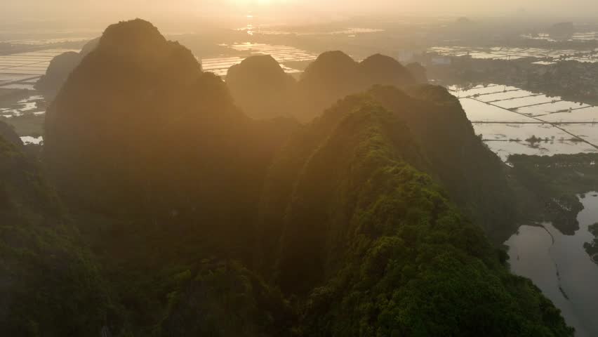 aerial view of scenic sunrise in Vietnam, beautiful nature of Southeast Asia, travel in Vietnam, Vietnamese mountains of Ninh Binh 