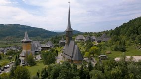 Aerial footage of Barsana monastery located in Maramures County, Romania. Video was taken from a drone at a lower altitude with camera level for a landscape view of Barsana monastery assembly.