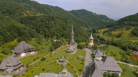 Aerial footage of Barsana monastery located in Maramures County, Romania. Video was taken from a drone at a higher altitude with camera level for a landscape view of Barsana monastery assembly.