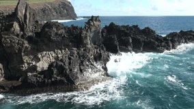 Powerful waves of the Atlantic Ocean. Waves and rocks of the Atlantic Ocean. Beautiful seascape. View of the Atlantic azure ocean and giant waves crashing against a rocky cliff with splashes. - Powered by Shutterstock - Get 15% off with code: PIKWIZARD15