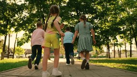 Children play in city park, friends run along paths together. Happy childhood dream concept. Happy boy, girl run, play together in outdoor. Family, weekend in nature. Brother sister, healthy lifestyle - Powered by Shutterstock - Get 15% off with code: PIKWIZARD15