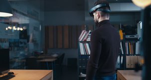 FIXED Back view of young adult Caucasian male employee using holographic augmented reality glasses in trendy office. Future concept. 4K UHD RAW edited footage 