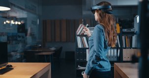 FIXED Back view of young adult Caucasian female using holographic augmented reality glasses in trendy office. Future concept. 4K UHD RAW edited footage 