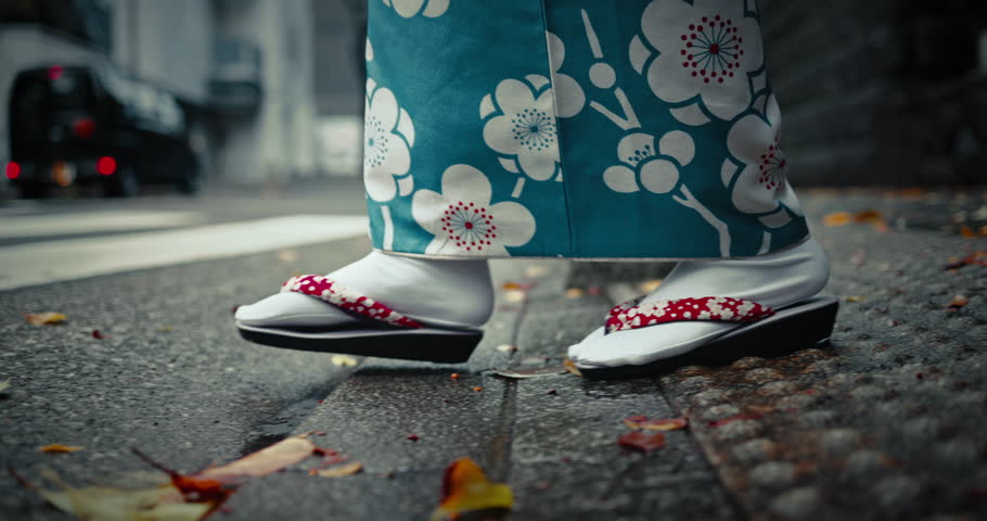 Japan, feet and walking in city in kimono, pedestrian crossing and woman in street for heritage. Person, commuting and traditional clothes in tokyo religion and travel in slippers as culture fashion
