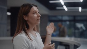 Female administrator speaks with patient at reception desk in clinic lobby area. Woman at information counter consults person in hospital. Medical staff works in modern medical center. Health care. - Powered by Shutterstock - Get 15% off with code: PIKWIZARD15