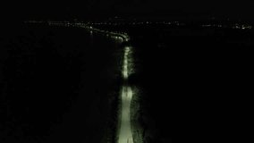 Aerial view of Road in the Middle of the Lake at Night