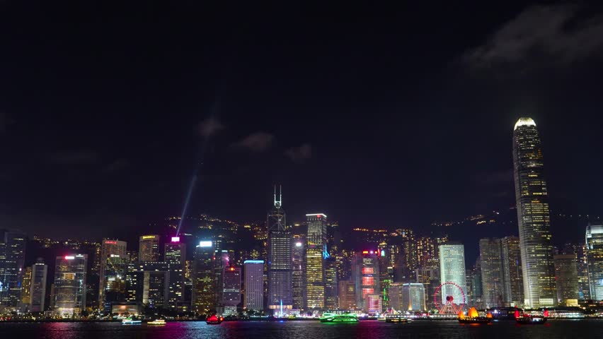 Hong Kong at night light show on skyscrapers near the bay