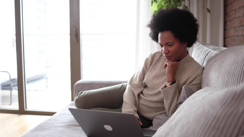 Woman watching something on her laptop