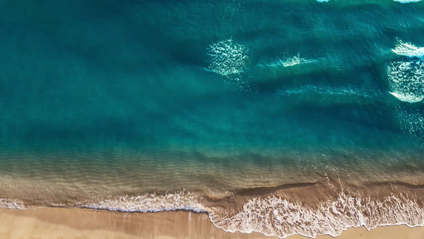 Aerial view drone over beach sea, beautiful sea waves. Beach sand and azure seawater