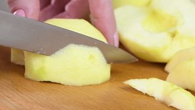 Cut a peeled apple into slices to prepare a French apple pancake recipe. One of part of a series of video recipes. Real time, close-up.