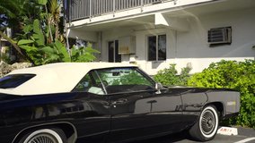 4k hdr video old classic car parked in a Miami Beach scene