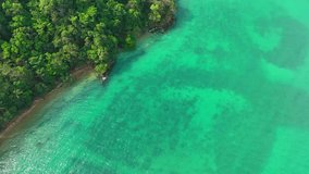 A breathtaking aerial vista showcases the exquisite charm of a tropical sea, where tranquil blues meet golden sands. Ecotourism and biodiversity concept. Ko Chang, Trat Province, Thailand. 4K HDR.
