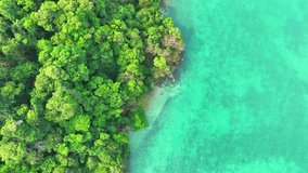Captivating aerial shot reveals a tropical sea's beauty, a symphony of vibrant blues and lush greens, nature's masterpiece. Destinations and exploration concept. Ko Chang island, Thailand. 4K HDR.
