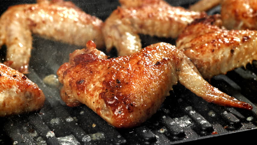 Chicken wings are fried in a pan. Filmed on a high-speed camera at 1000 fps. High quality FullHD footage