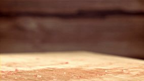 A fresh beef burger falls onto a cutting board. Filmed on a high-speed camera at 1000 fps. High quality FullHD footage
