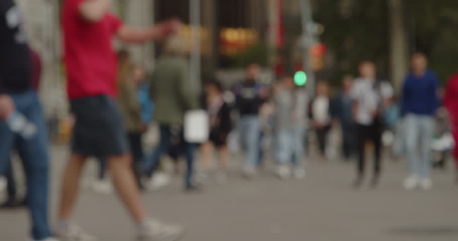 Timelapse of an out-of-focus crowd of pedestrians walking on a street in a big city. Metropolis concept