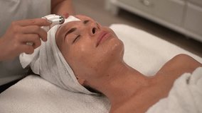 woman receiving massage. microcurrent machine. microcurrents for the face. Slow-motion video. High quality video in 4K format.
