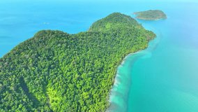 Drone's perspective reveals a paradise island's stunning blend, vibrant rainforests, towering mountains, and turquoise waters mirroring the tropical sky. Nature stock footage. Trat Province, Thailand.