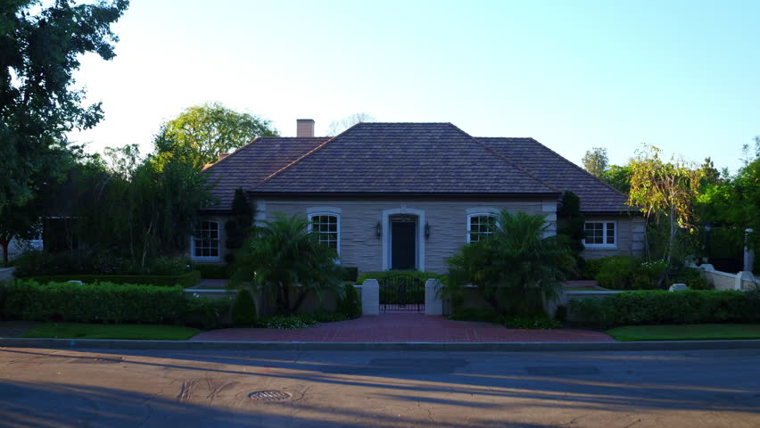 Aerial: Drone Forward Panning Shot Of Residential Roofed House By Golf Course Against Clear Sky - Long Beach, California