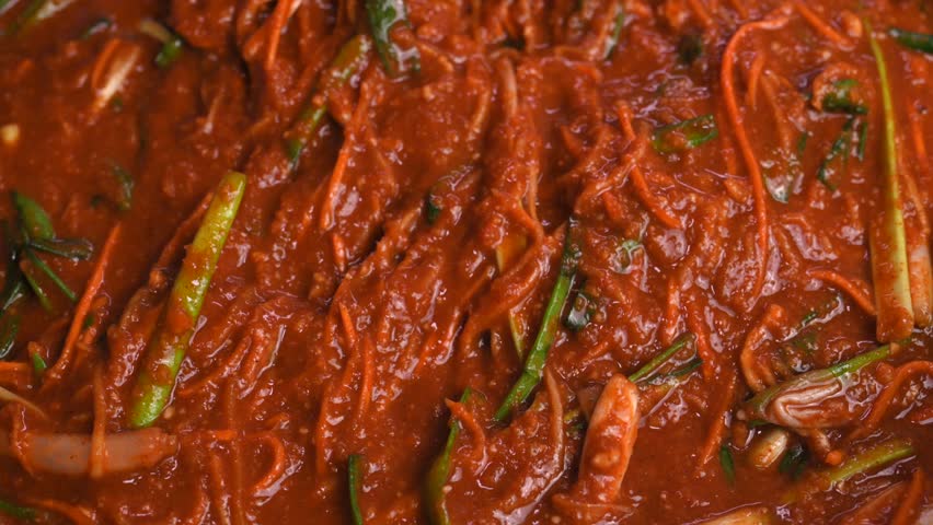 Stir the  korean kimchi sauce with a spoon.Korean kimchi sauce. Korean traditional  kimchi sauce. Closeup. Royalty-Free Stock Footage #3427026635