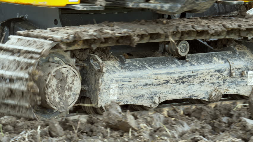 A closer shot of the track rails and rollers of a heavy duty bulldozer, a heavy equipment used for farming and buidling infrastructure.