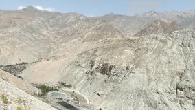a beautiful mountainous View of a highway in Kyrgyzstan, high mountains location with the rock sedimentation, high quality Blog video.