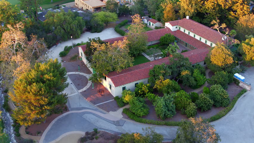 Aerial Panning Shot Of Roofed Houses On Green City Landscape - Long Beach, California