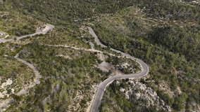 Drone shot of driving car on the road in the Esporles valley on the island village of Mallorca in the Serra de Tramuntana, Spain