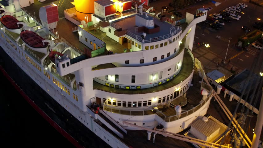Aerial: Drone Panning Shot Of Illuminated Luxurious Ship Moored In Ship At Night - Long Beach, California