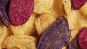 Tricolor sweet potato chips, rotation in circle. Fried chips from the barracks (fast food), Turning. selective focus. vegetable chips. Vertical video