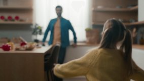 Caucasian happy family at kitchen little child kid girl run hurry running to lovely dad father lift daughter in his arms up rise rotate at home cooking food morning meeting love bonding childcare - Powered by Shutterstock - Get 15% off with code: PIKWIZARD15