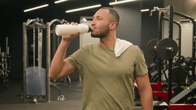 Happy satisfied Latino man athlete walk go to start workout exercise with towel on shoulder finish training fit sport guy fitness trainer instructor male bodybuilder sportsman in gym drinking water - Powered by Shutterstock - Get 15% off with code: PIKWIZARD15